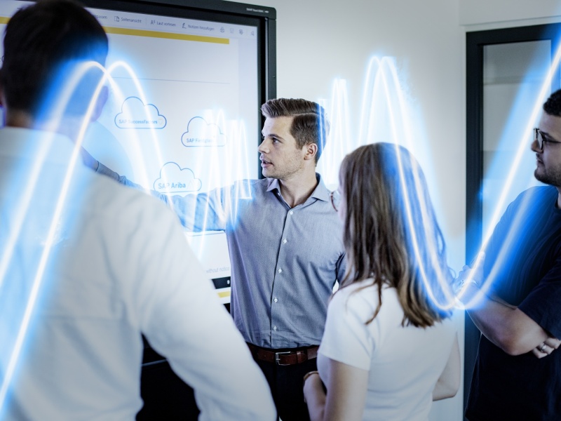 Employees talking on the whiteboard